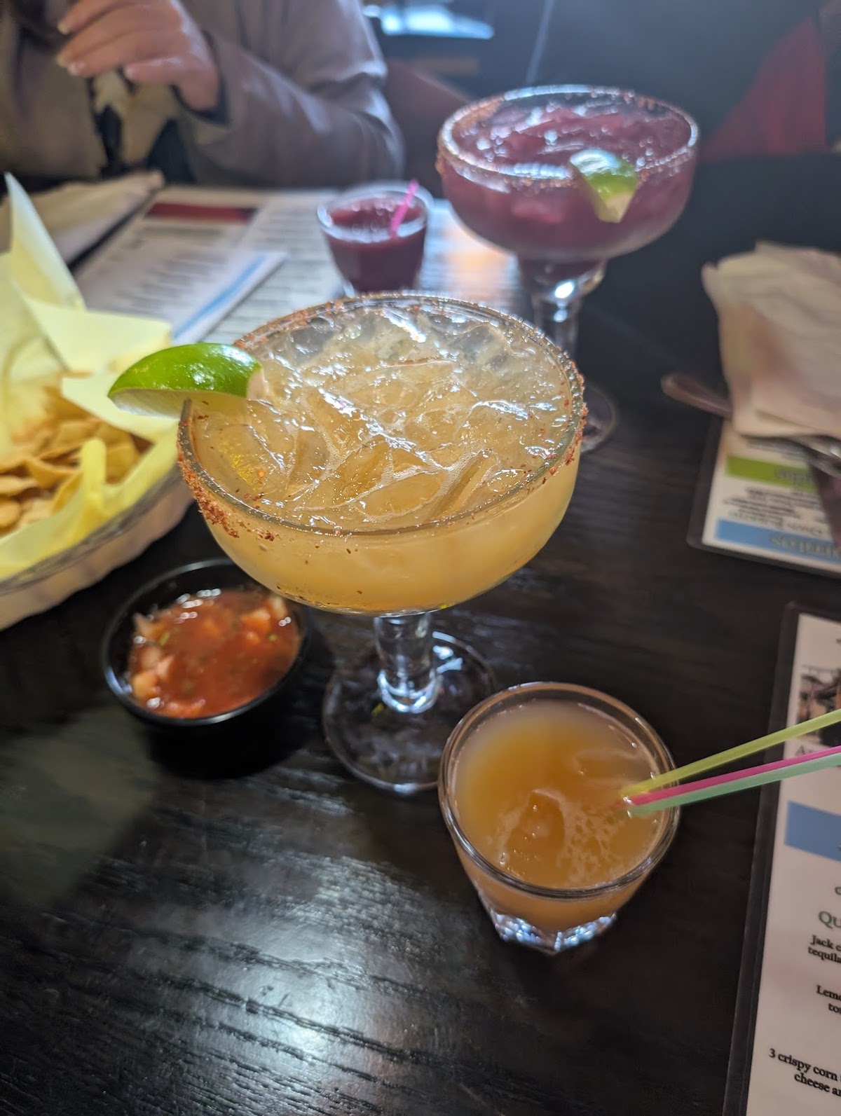 Classic and watermelon margaritas with chips and salsa on the table